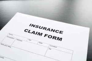 Insurance claim form with glasses.