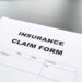 Insurance claim form with glasses.